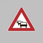 Triangle traffic sign with cars on it